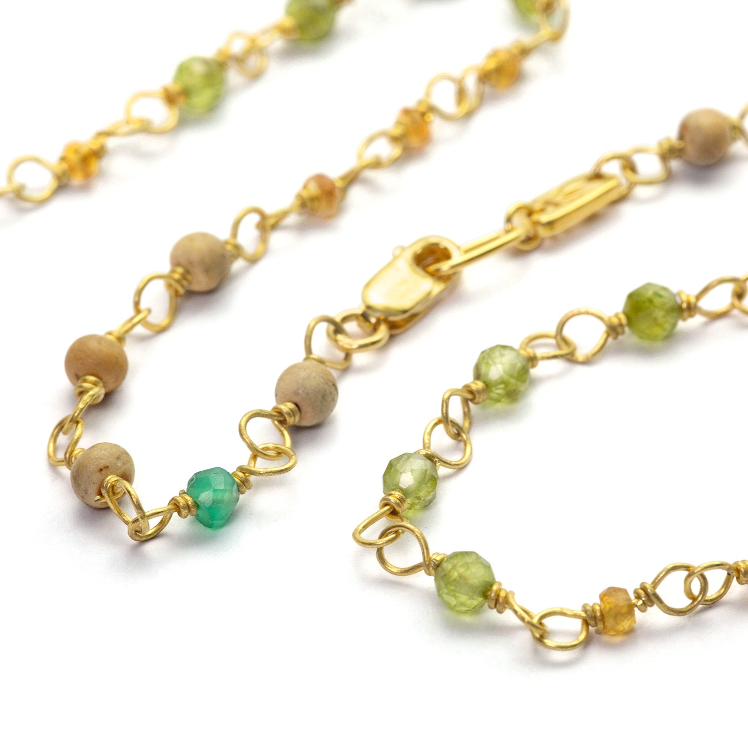 Detail of gemstone necklace "Inspiration" made of gold-plated sterling silver with emerald, sapphire, peridot and sandalwood by Eternal Bliss