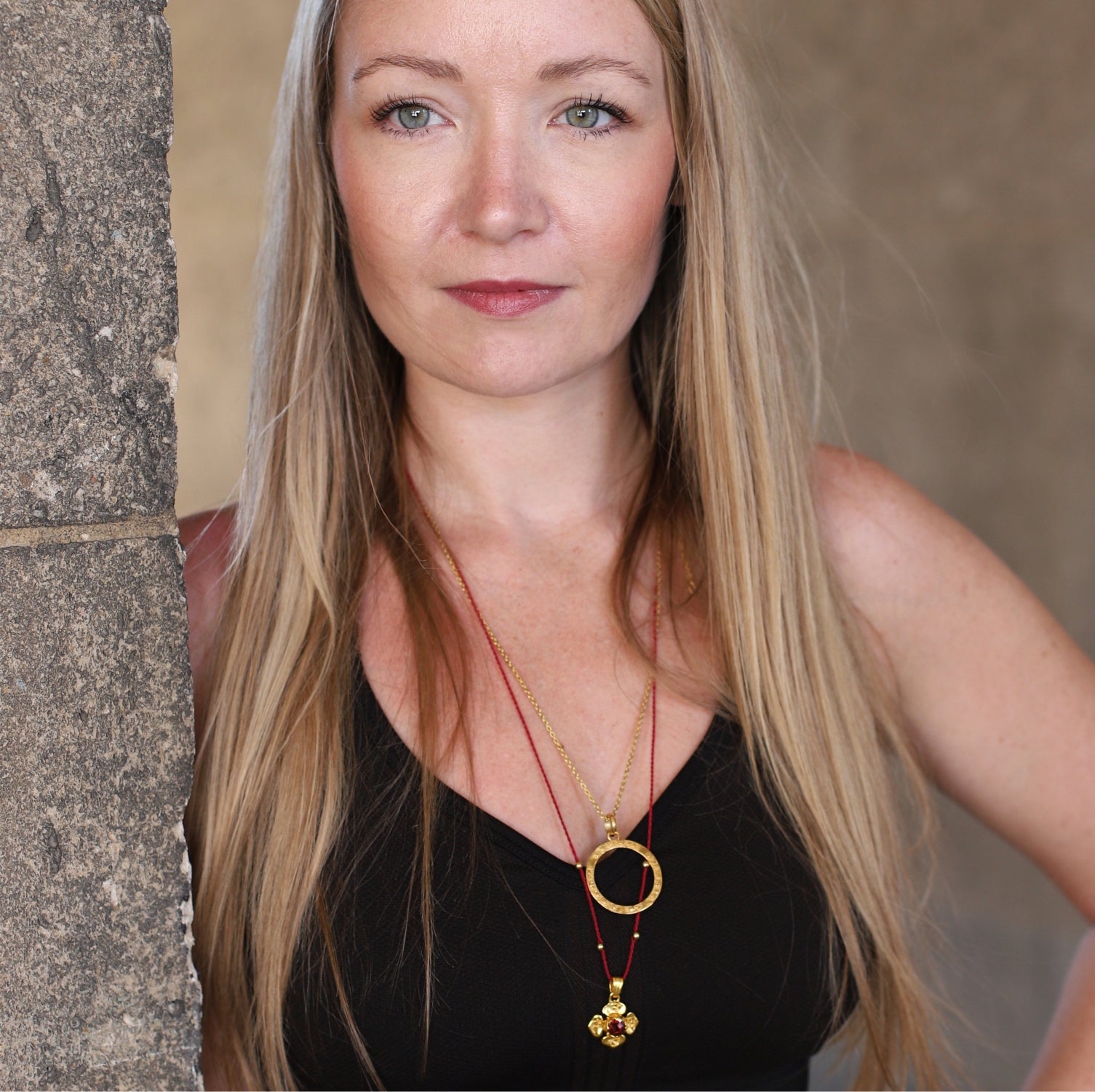 Hedy aus Wiesbaden, kombiniert eine Wurzel Chakra Kette mit Granat mit einer Kali Mantra Kette aus hochwertig vergoldetem Sterling Silber von ETERNAL BLISS